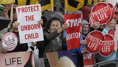 
              Protesters opposed to abortion hold placards outside the Marie Stopes clinic in Belfast, Northern Ireland, Thursday, 18, 2012. The first abortion clinic on the island of Ireland has ope
